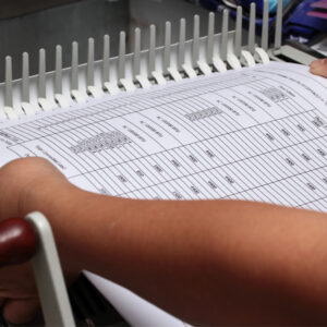 a document being put into a binding machine