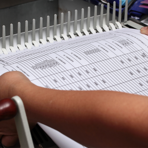 a document being put into a binding machine